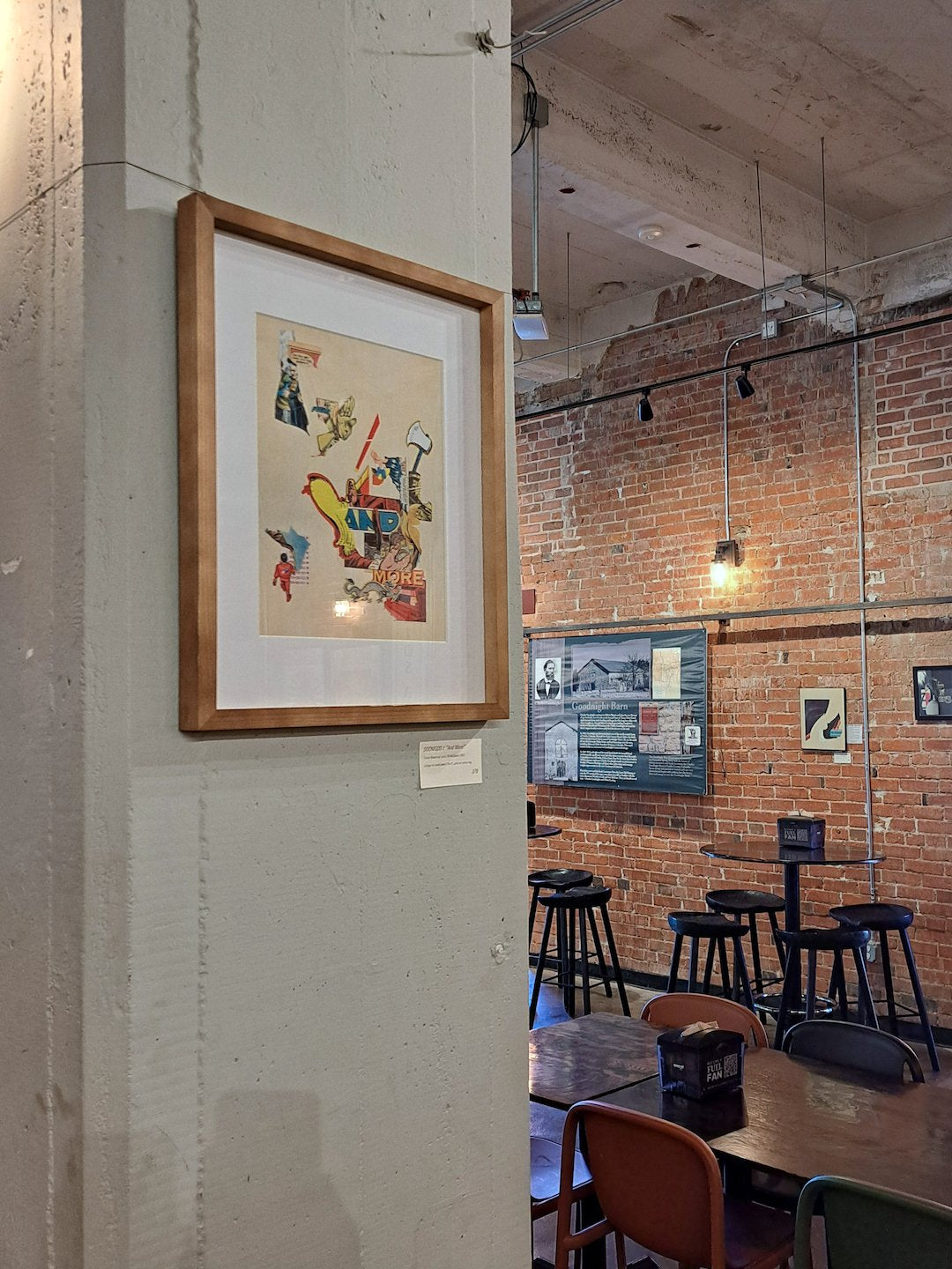 The work on display, hanging on a concrete pillar in a wooden frame.
