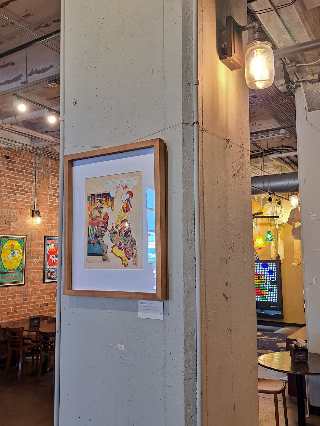 The work on display, hanging on a concrete pillar in a wooden frame.