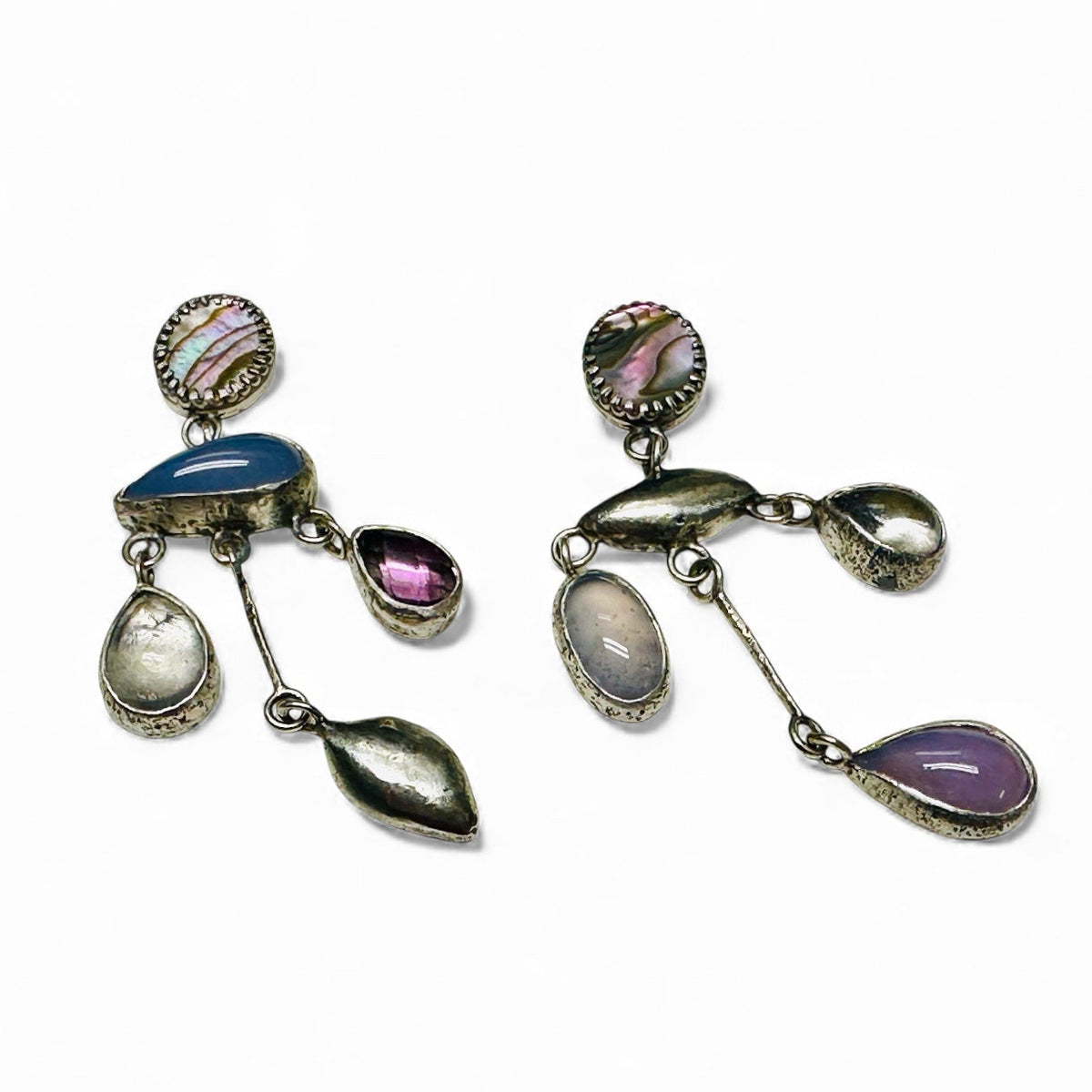A pair of silver-toned dangle earrings with multiple colorful gemstone and shell-like charms, displayed on a clean white background.