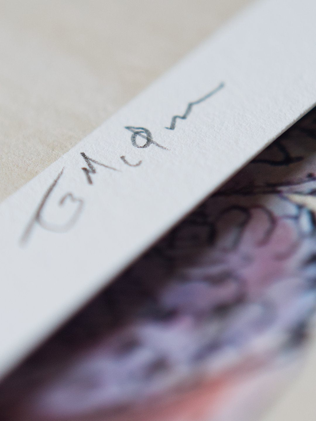 A macro closeup showing the artist signature in the margin.